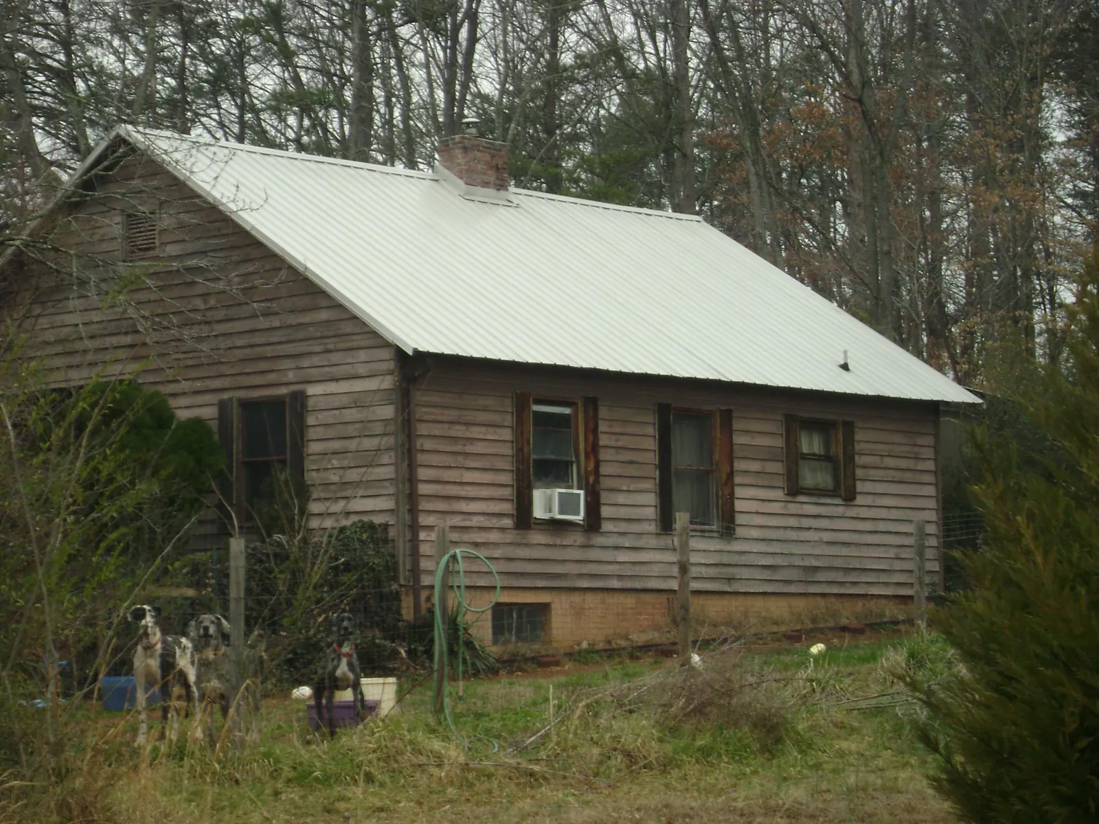 White metal roof on an old wood sided farmhouse, from a Metal Roof Installation job in Highfalls